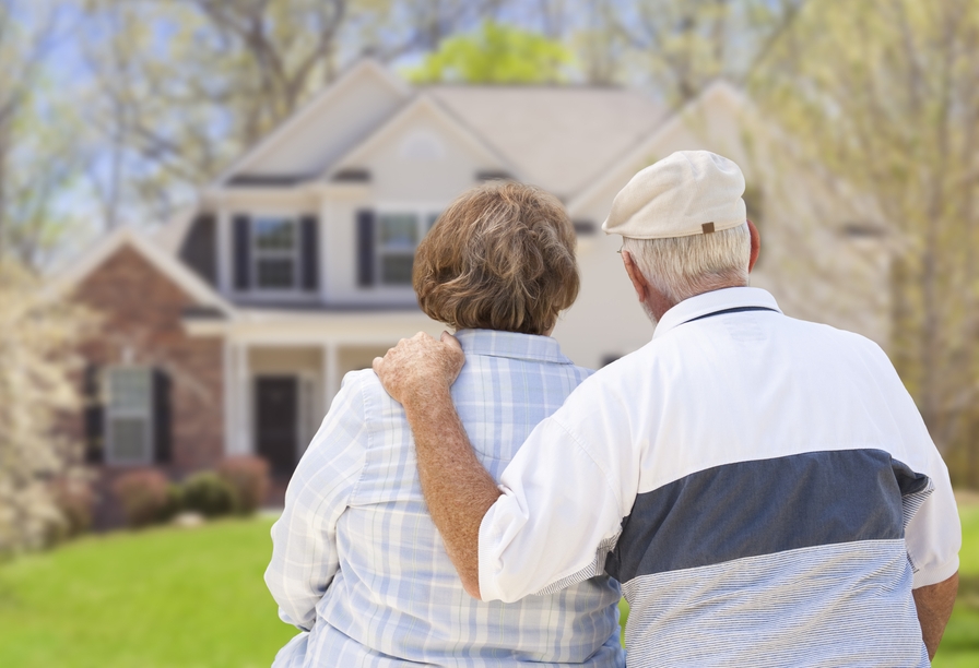Elderly couple looking at a house